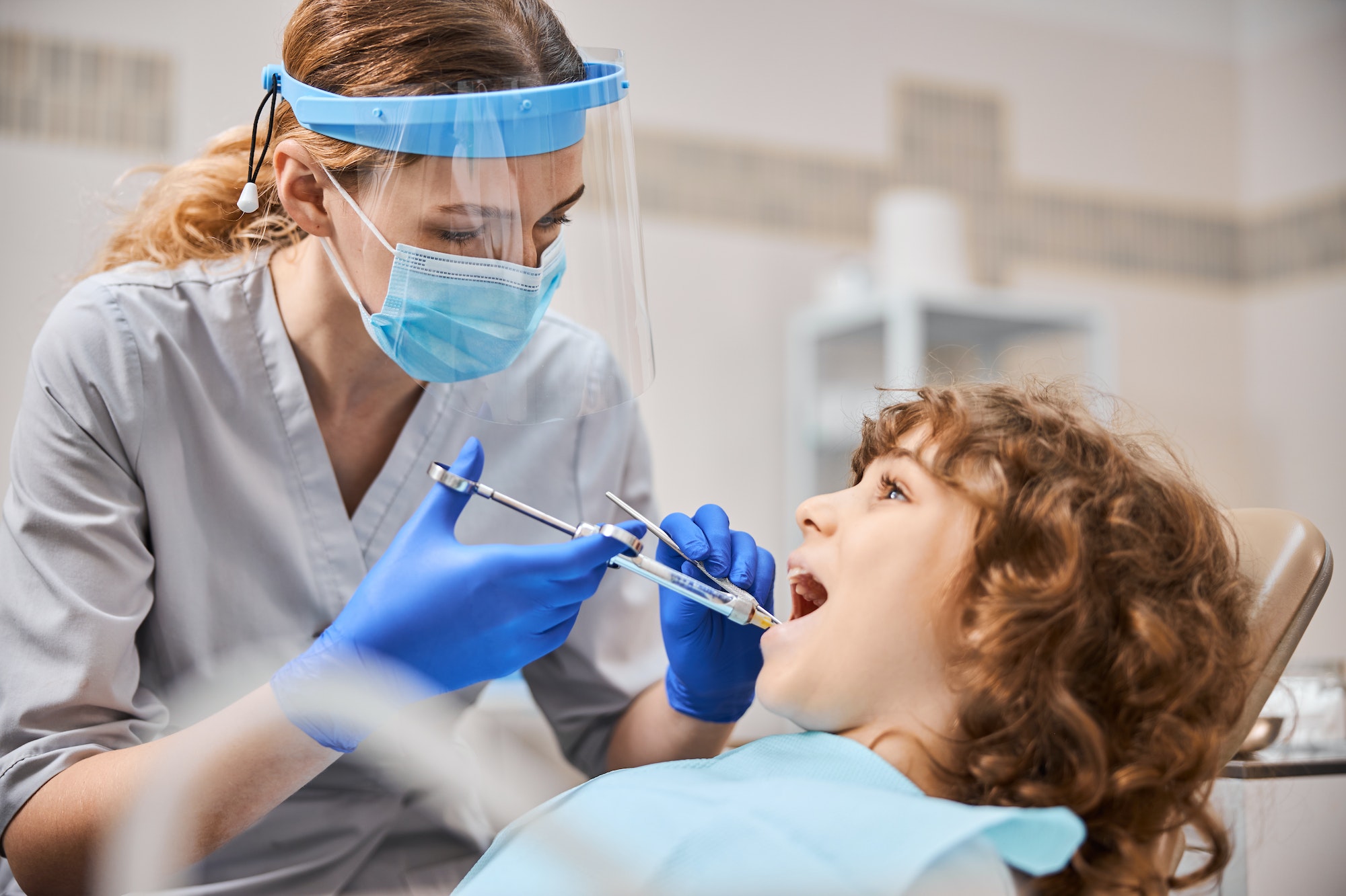 professional-dentist-is-giving-anesthesia-to-a-child